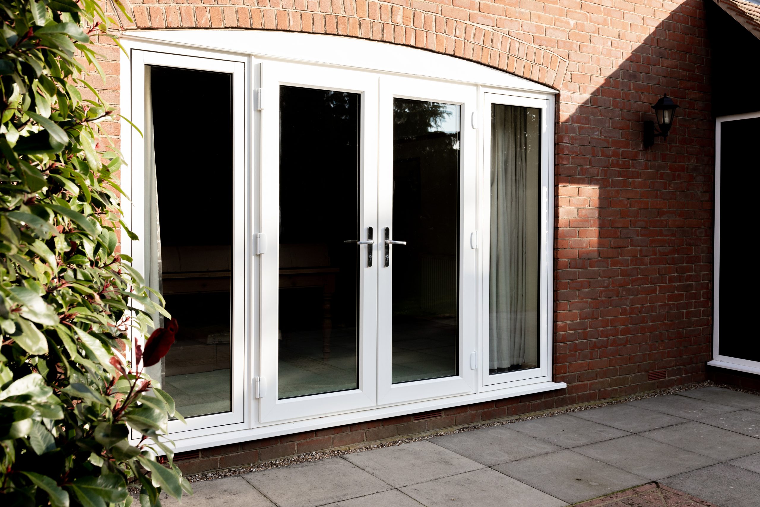 classic white French door on brick building